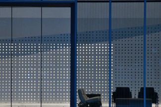 Waiting area chairs in front of large blue window screen