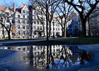 View of UChicago building standing above a reflective