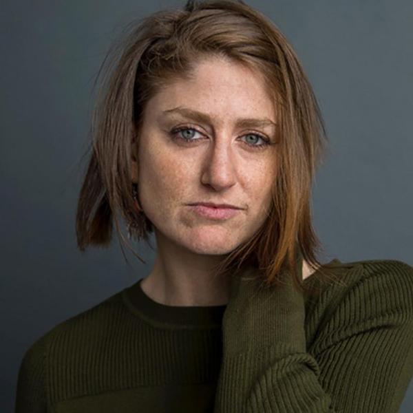 Portrait of Leah Feldman in front of a dark blue background