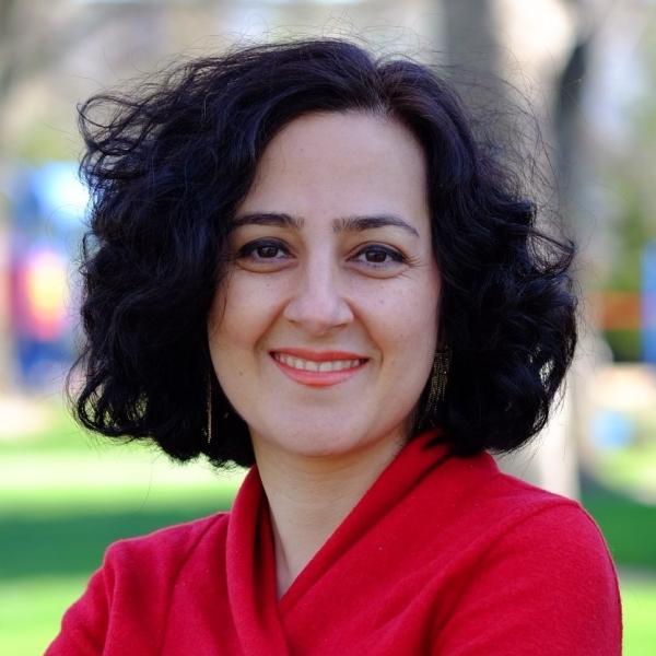 Portrait of Mehrnoush Soroush outside on UC campus with blurred trees in the background