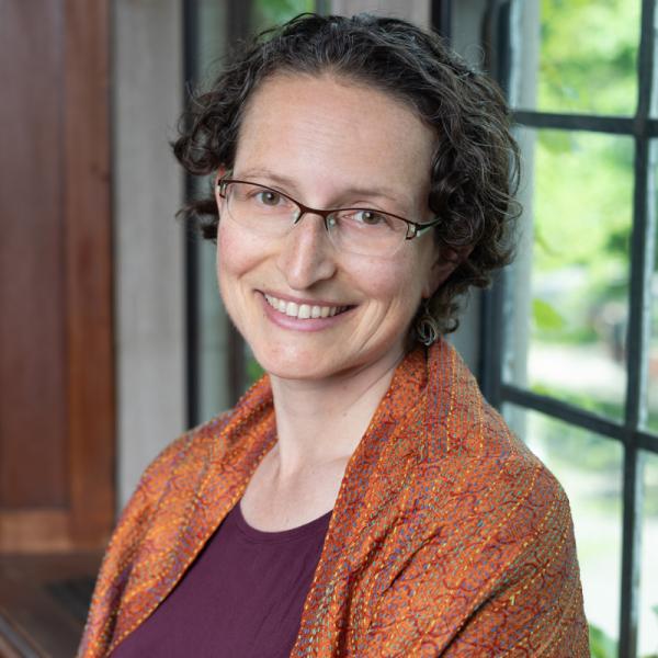 Portrait of Claudia Brittenham indoors in front of a large paneled window
