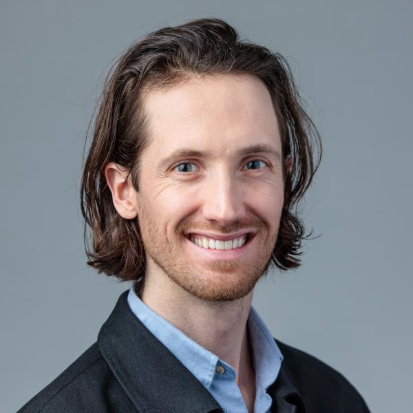 Portrait of Chris Gortmaker in front of a blue-grey background