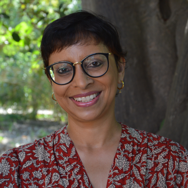 Portrait of Rochona Majumdar outside on UC campus in front of a tree