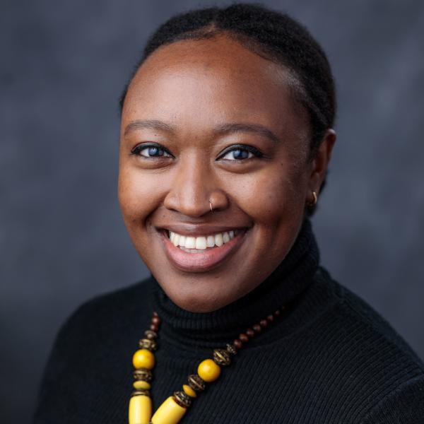 Portrait of Sharese King in front of a dark grey background